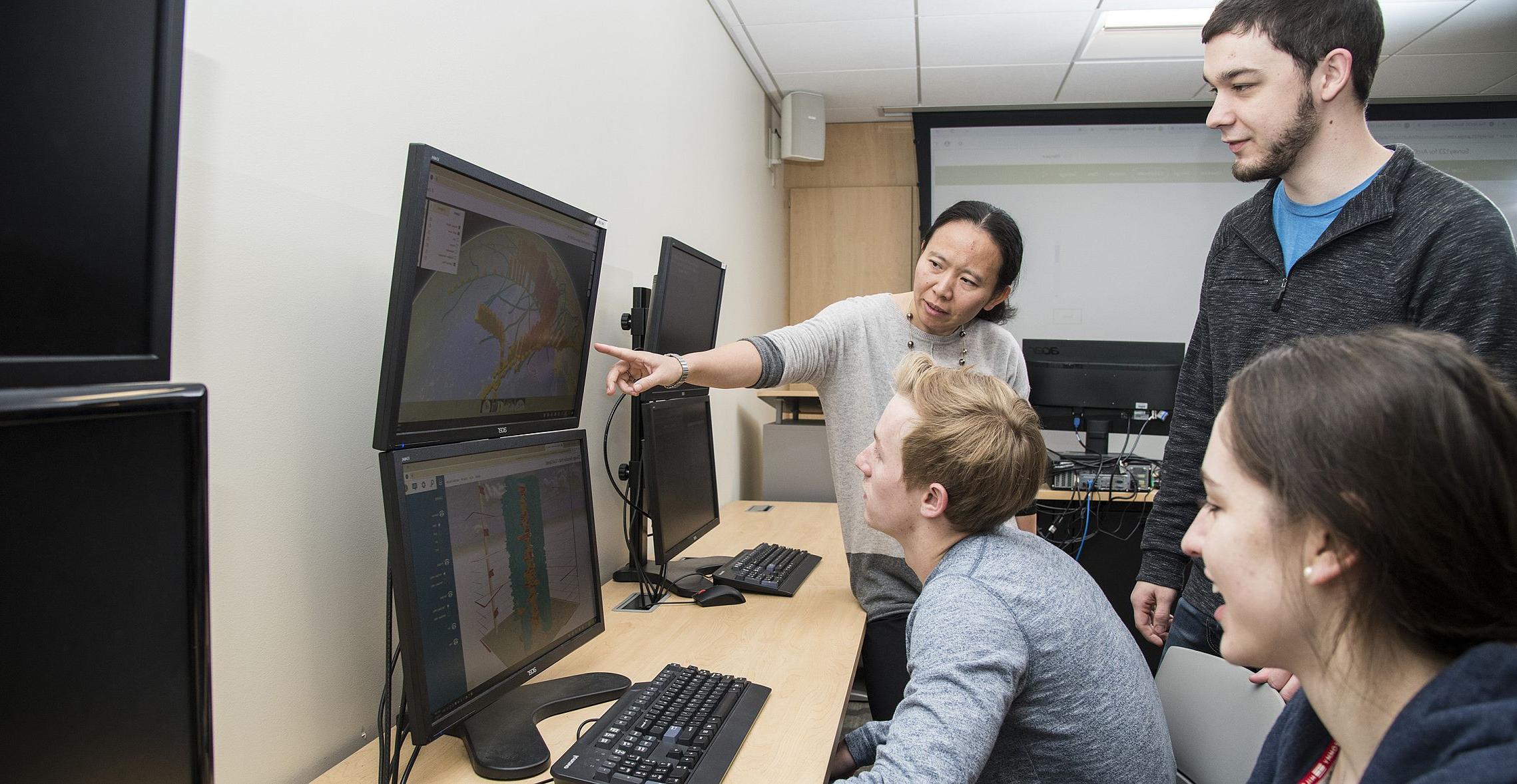 Students pursuing a geographic information science degree in a classroom.